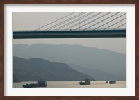 Framed Container ships passing a newly constructed bridge on the Yangtze River, Wanzhou, Chongqing Province, China