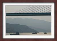 Framed Container ships passing a newly constructed bridge on the Yangtze River, Wanzhou, Chongqing Province, China