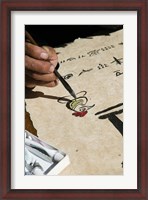 Framed Chinese calligrapher painting calligraphy on a paper at the Dongba Place, Old Town, Lijiang, Yunnan Province, China