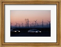 Framed Cars moving on road with wind turbines in background at dusk, Palm Springs, Riverside County, California, USA