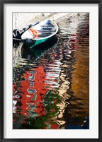 Framed Houses and boat reflected in Lake Como, Varenna, Lombardy, Italy