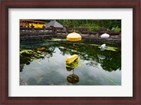 Framed Covered stones with umbrella in ritual pool at holy spring temple, Tirta Empul Temple, Tampaksiring, Bali, Indonesia