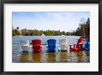 Framed Adirondack chairs partially submerged in the Lake Muskoka, Ontario, Canada