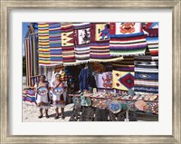 Framed Two female vendors dressed in Mayan costumes displaying products