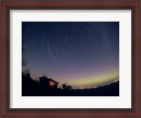 Framed Circumpolar star trails with a faint aurora over horizon, Alberta, Canada