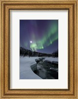 Framed Aurora Borealis over the Blafjellelva River in Troms County, Norway