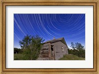 Framed Circumpolar star trails above an old farmhouse in Alberta, Canada