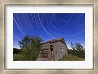 Framed Circumpolar star trails above an old farmhouse in Alberta, Canada