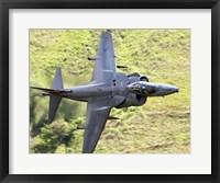 Framed Royal Air Force Harrier GR9 flying low over North Wales