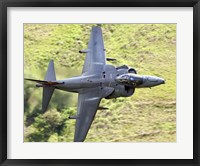 Framed Royal Air Force Harrier GR9 flying low over North Wales