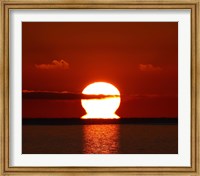 Framed omega-shaped sunrise above the water in Buenos Aires, Argentina