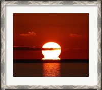 Framed omega-shaped sunrise above the water in Buenos Aires, Argentina