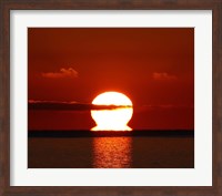 Framed omega-shaped sunrise above the water in Buenos Aires, Argentina