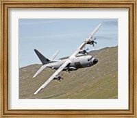 Framed C-130J Super Hercules low flying over North Wales on a training flight