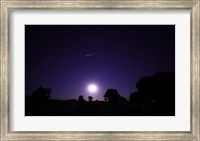 Framed bolide from the Geminids meteor shower above a setting moon in Mercedes, Argentina