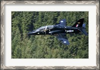 Framed Hawk T1 trainer aircraft of the Royal Air Force flying over a forest in North Wales