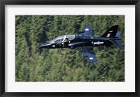 Framed Hawk T1 trainer aircraft of the Royal Air Force flying over a forest in North Wales