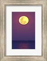 Framed Thunder's Moon and its reflection above the water