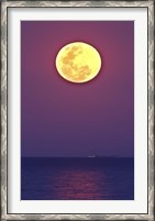 Framed Thunder's Moon and its reflection above the water
