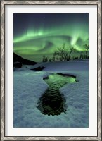 Framed Aurora Borealis over a frozen river, Norway