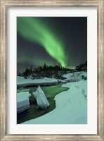 Framed Aurora Borealis over a frozen Tennevik River, Troms, Norway