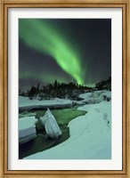 Framed Aurora Borealis over a frozen Tennevik River, Troms, Norway