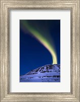 Framed aurora borealis shooting up from Toviktinden Mountain, Norway