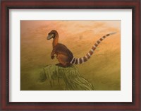 Framed Sinosauropteryx dinosaur resting on a log