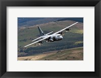 Framed C-130 Hercules of the Royal Air Force flying over North Wales
