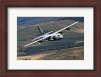 Framed C-130 Hercules of the Royal Air Force flying over North Wales
