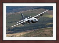 Framed C-130 Hercules of the Royal Air Force flying over North Wales