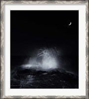 Framed crescent moon and waves splashing over rocks in Miramar, Argentina