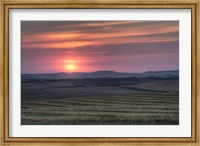 Framed Setting sun over harvested field, Gleichen, Alberta, Canada