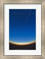 Framed Trail of the International Space Station coming out of the western twilight