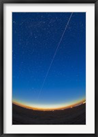 Framed Trail of the International Space Station coming out of the western twilight