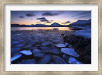 Framed Ice flakes drifting against the sunset in Tjeldsundet strait, Troms County, Norway