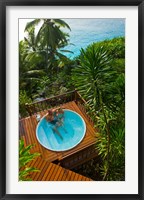 Framed Couple enjoying hot tub at Fregate Resort, Seychelles