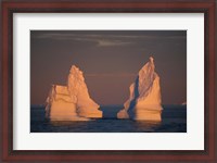 Framed Antarctic Peninsula, icebergs at midnight sunset.
