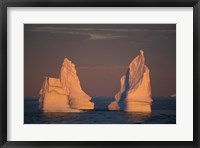 Framed Antarctic Peninsula, icebergs at midnight sunset.
