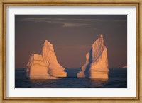 Framed Antarctic Peninsula, icebergs at midnight sunset.