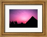 Framed Colorful Sunset Silhouetting Men and Camels at the Great Pyramids of Giza, Egypt