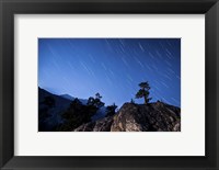 Framed Whisps of moonlight shine through the mountain peaks of Inyo National Forest