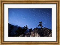 Framed Whisps of moonlight shine through the mountain peaks of Inyo National Forest