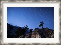 Framed Whisps of moonlight shine through the mountain peaks of Inyo National Forest