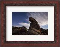 Framed Large boulders backdropped by stars and clouds, California