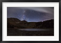 Framed Star trails and the blurred band of the Milky Way above a lake in the Eastern Sierra Nevada