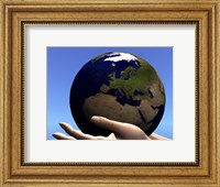 Framed planet Earth is held in caring human hands