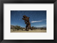 Framed Tyrannosaurus rex sculpture against a backdrop of star trails, California