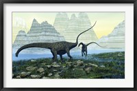 Framed Diplodocus dinosaurs munch on vegetation near a mountain lake