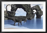 Framed Diplodocus dinosaurs wade through shallow waters of a beautiful seashore